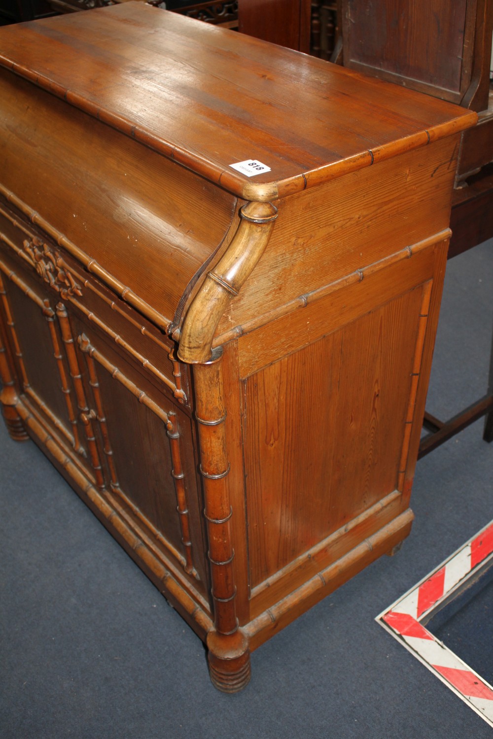 An Edwardian pine washstand, the rising top opening to reveal marble lined interior and mirror, over a drawer and bamboo moulded cupboa